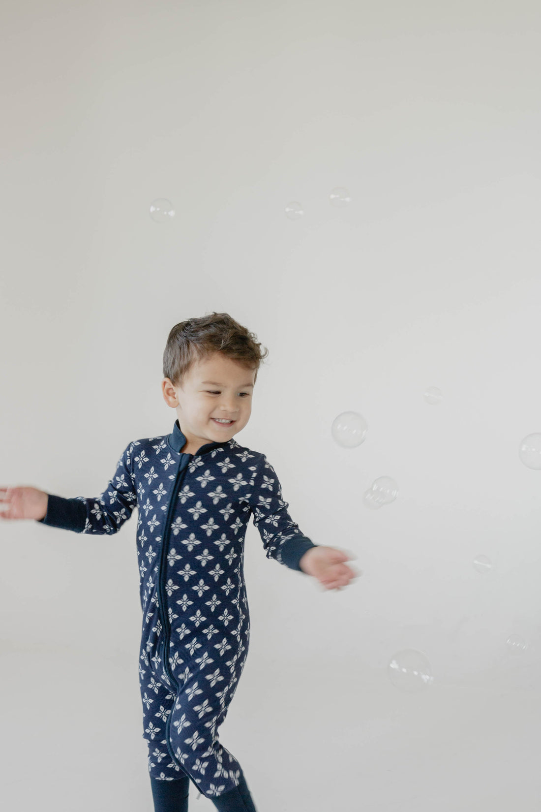 Soft, non-ribbed footies made from a gentle cotton blend, designed for sensitive skin. Features a comfy stretch for easy movement and a covered double zipper for quick, tear-free changes. Foldover hands and gripped feet coming soon.